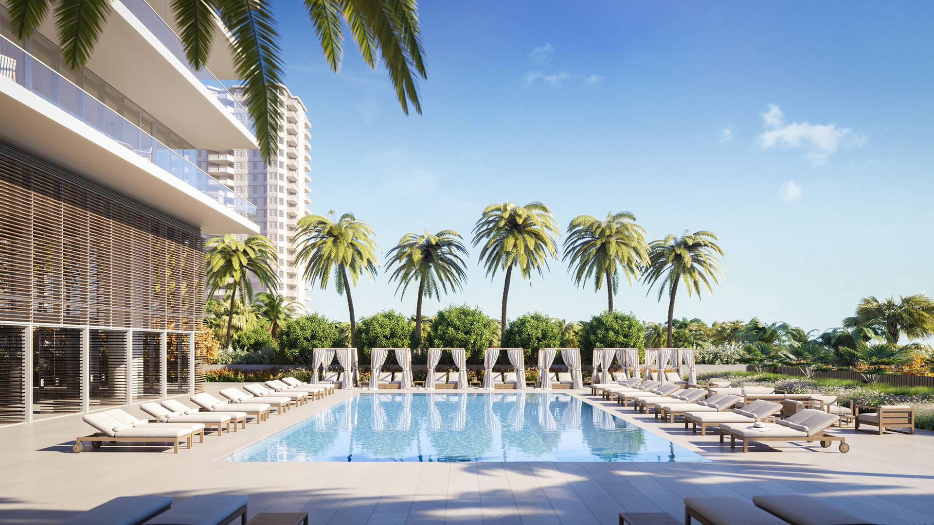 2000 Ocean Hallandale Beach resort-style pool with cabanas, loungers and palm landscaping, showcasing luxury and ultra luxury resale condos amenities on the South Florida oceanfront.