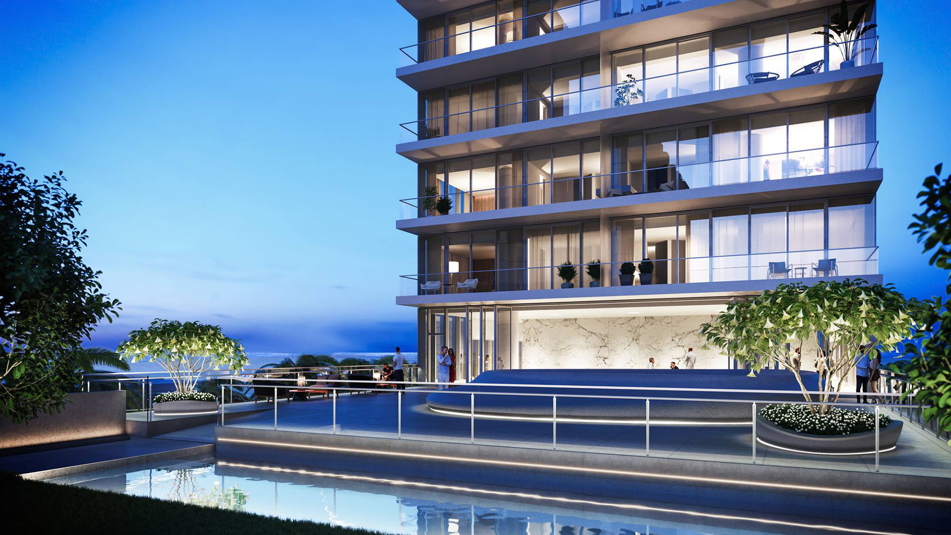 2000 Ocean in Hallandale Beach, Florida, oceanfront terrace at dusk with glass balconies, landscaped planters and reflecting pool, highlighting luxury and ultra luxury preconstruction condos.