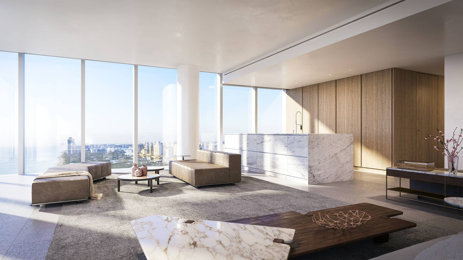 Sunlit interior at 2000 Ocean, Hallandale Beach, Florida, with marble kitchen island, open living area and panoramic skyline views, highlighting luxury and ultra luxury preconstruction condos.