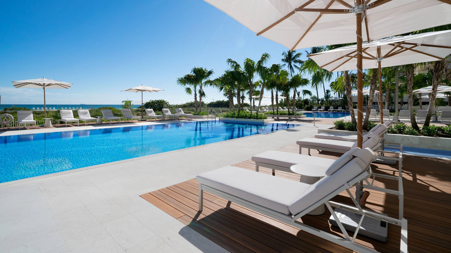 57 Ocean Miami Beach resort-style pool with loungers and cabanas, showcasing luxury and ultra luxury preconstruction condos amenities in Mid-Beach on Millionaire's Row, Miami Beach, Florida.