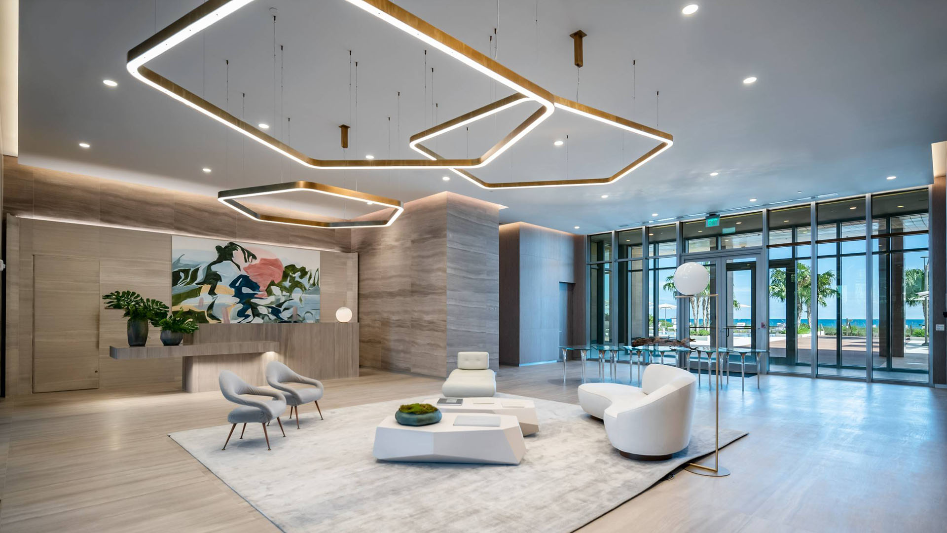 57 Ocean Miami Beach modern lobby with ocean view and floor-to-ceiling glass, showcasing luxury and ultra luxury preconstruction condos on Millionaire's Row, Mid-Beach, Miami Beach, Florida.
