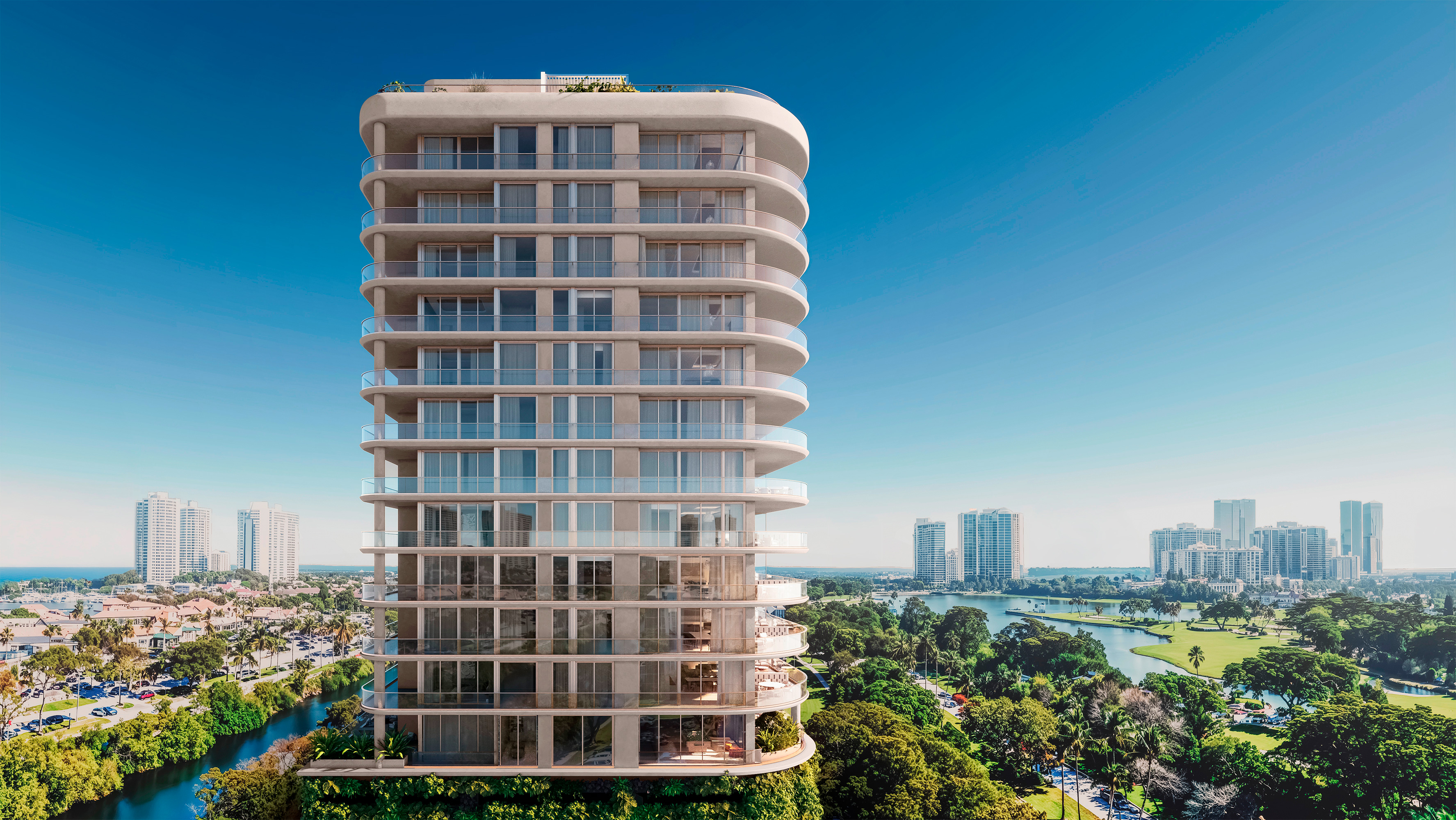 Avenia Aventura. Modern high-rise building with rounded edges, surrounded by greenery and cityscape, under a clear blue sky. Featuring apartment.