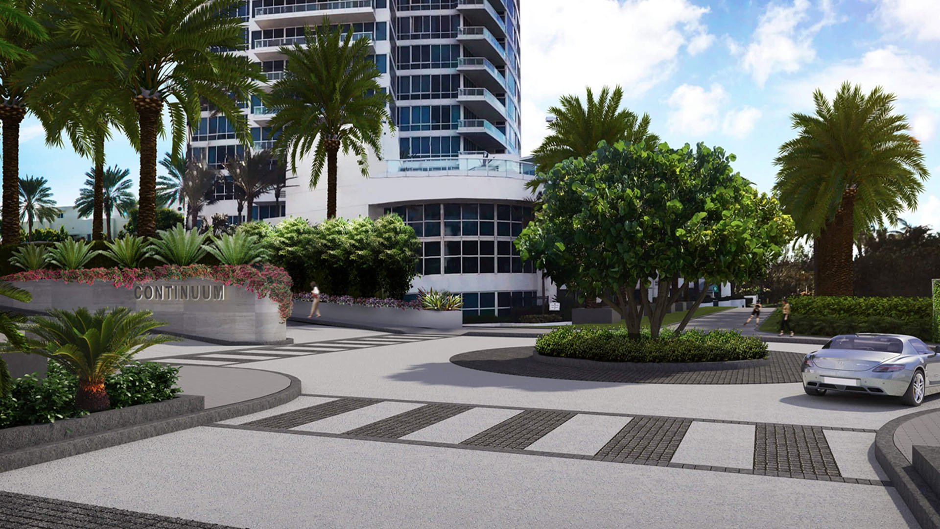 Arrival motor court and monument sign at Continuum on South Beach, Miami Beach, Florida, introducing luxury and ultra luxury condos with tropical landscaping, a circular drive, and the tower base in view.
