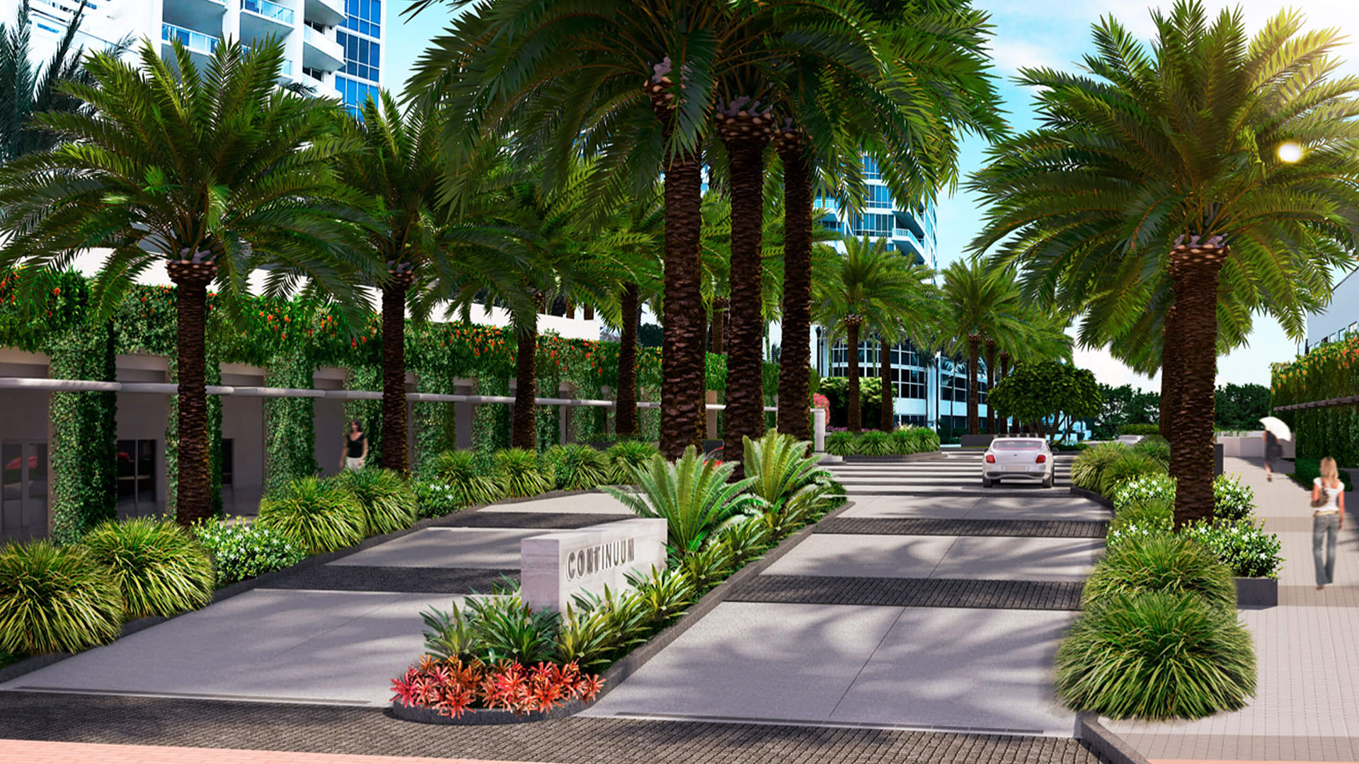 Palm-lined arrival drive at Continuum on South Beach, Miami Beach, Florida, leading into luxury and ultra luxury condos with lush landscaping, a landscaped median, and tower facades beyond.