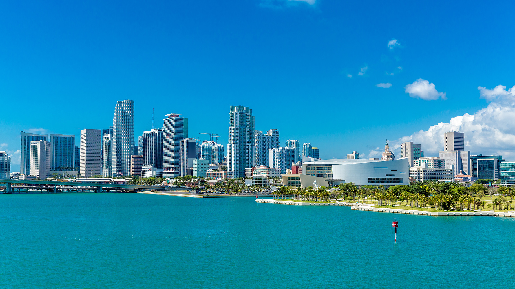 Downtown Miami bay view skyline over Biscayne Bay, sailboats and glass towers in Florida’s urban core; desirable location for luxury and ultra luxury condos, with preconstruction and resale opportunities.