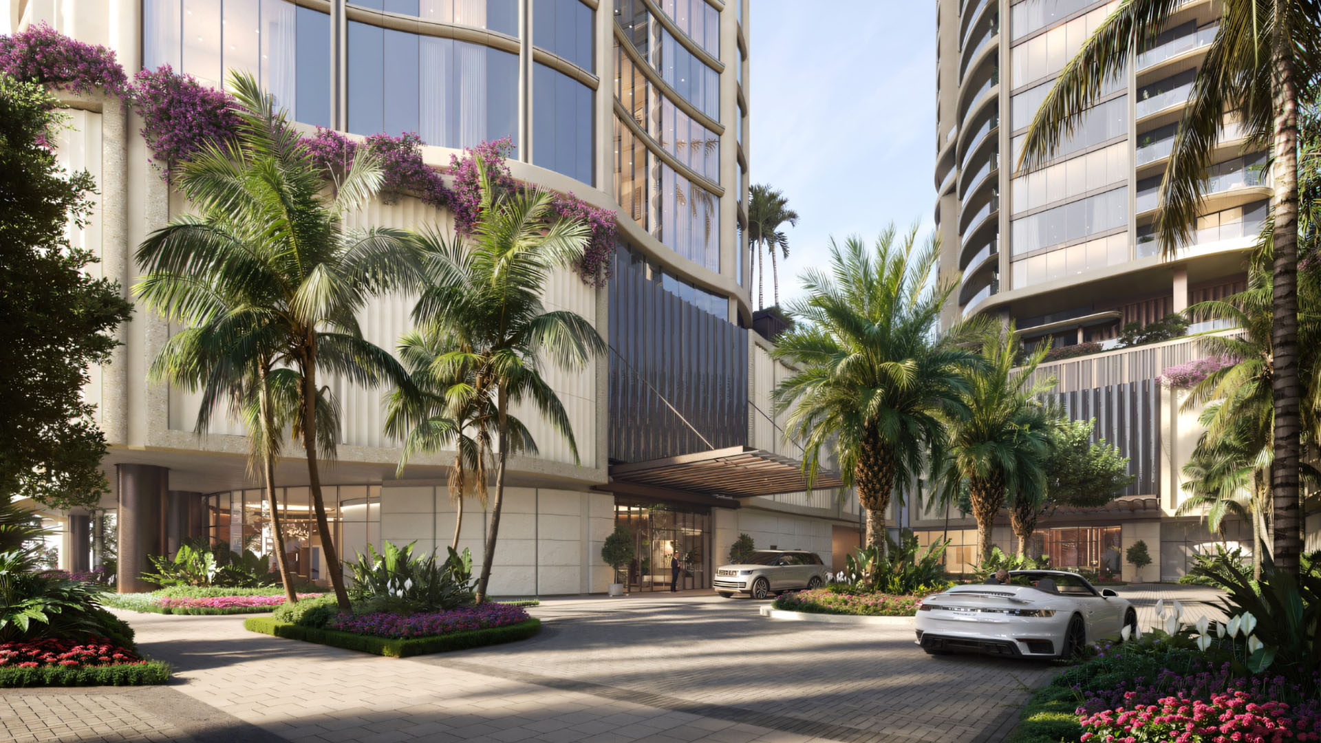 Edgeworth West Palm Beach luxury ultra luxury condos arrival court with a palm-lined motor court, porte cochere, landscaped entry gardens, and upscale residential tower facades.