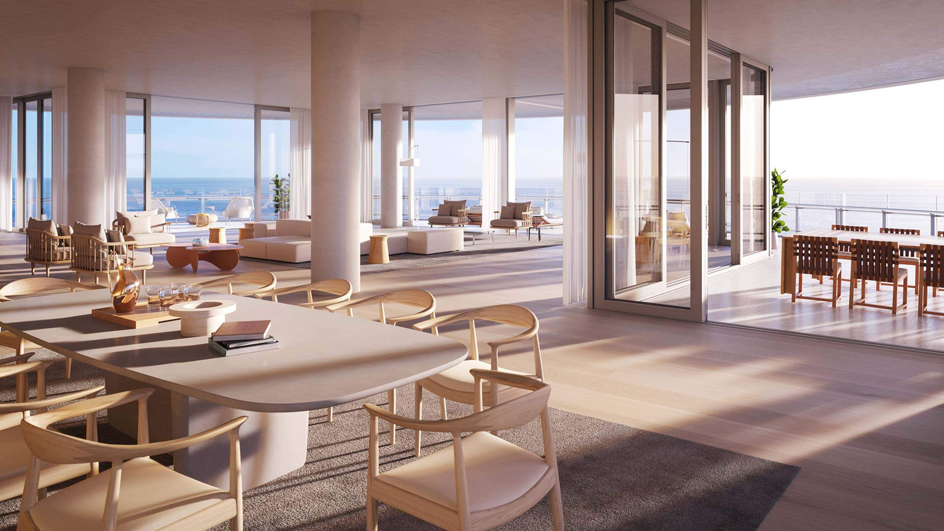Eighty Seven Park, Miami Beach luxury and ultra luxury condos open-plan great room and dining area flowing onto an expansive ocean terrace through floor-to-ceiling glass.