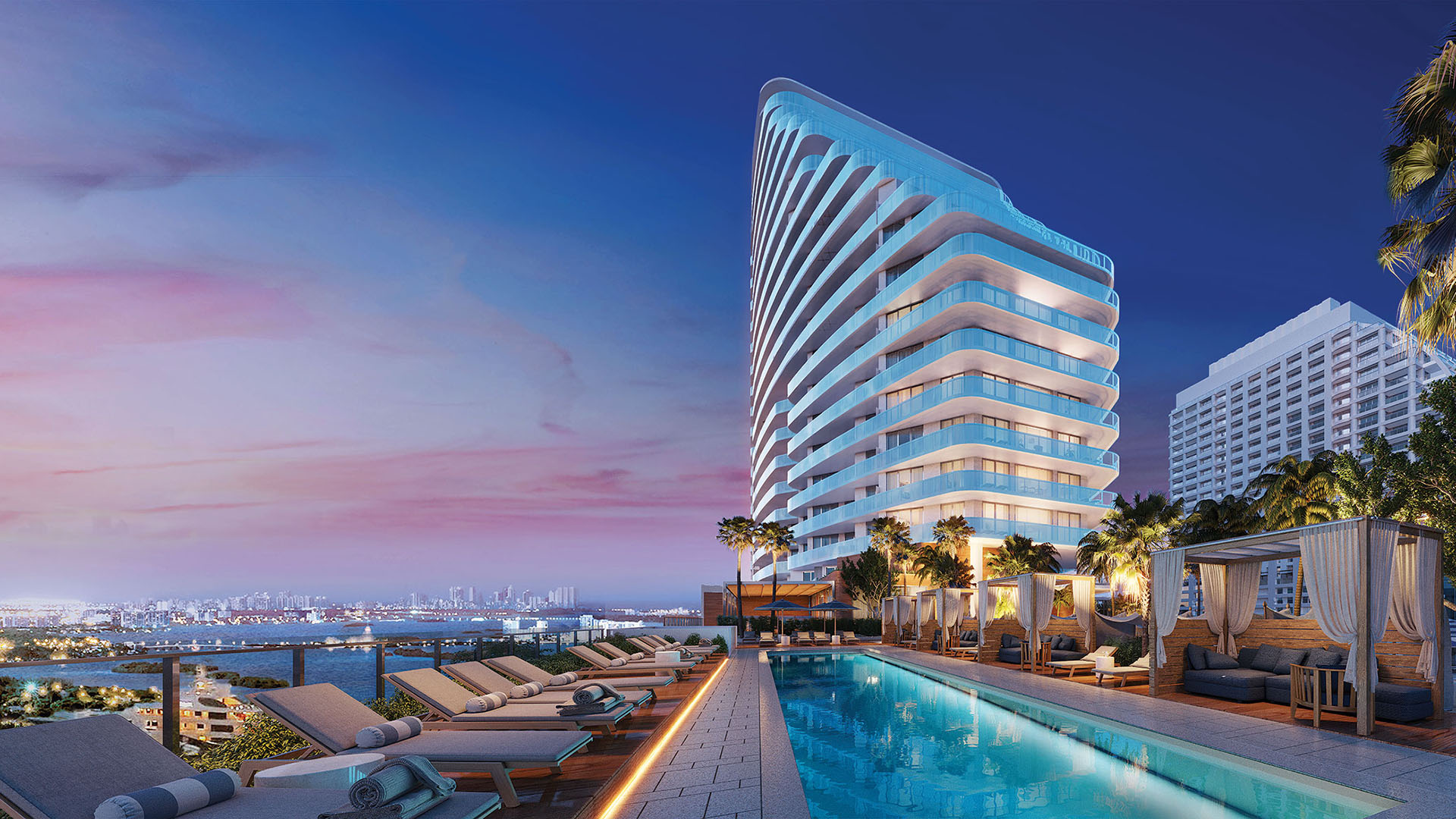 Curved tower exterior beside a long pool, cabanas, and twilight skyline views at Four Seasons Residences Fort Lauderdale in Fort Lauderdale, highlighting luxury and ultra luxury condos with signature waterfront design.