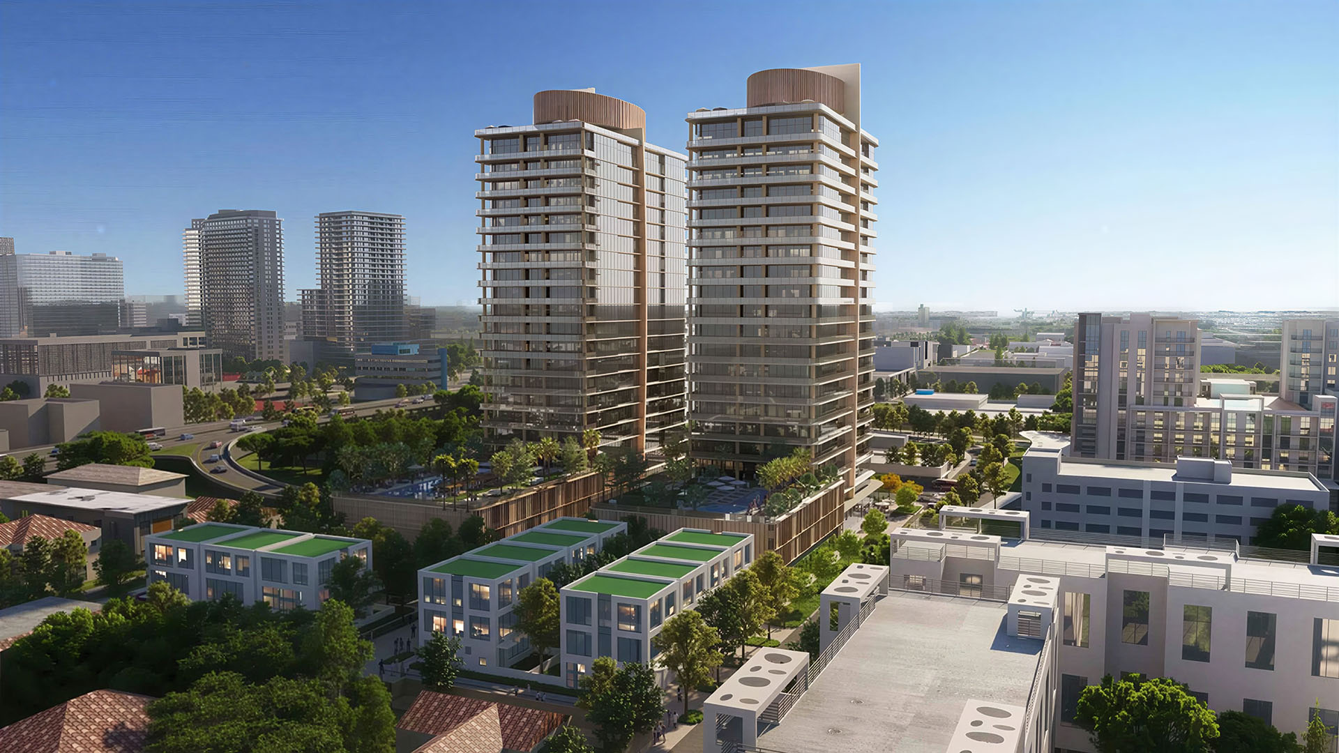 Kempinski Residences Miami in Miami Design District, luxury and ultra luxury condos, preconstruction aerial neighborhood view of twin towers rising above surrounding low-rise blocks with landscaped amenity decks and the city skyline in the distance.