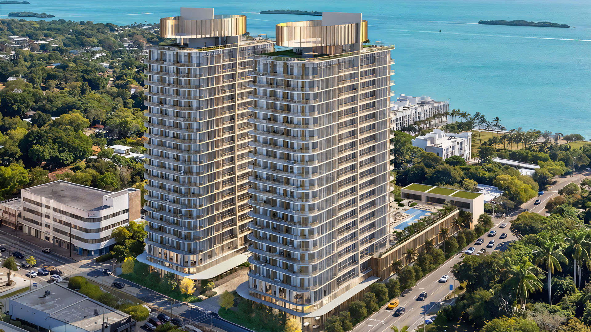 Kempinski Residences Miami in Miami Design District, luxury and ultra luxury condos, preconstruction aerial waterfront view of twin residential towers with curved balconies, rooftop crowns, a pool deck, and lush streets leading toward the waterfront.