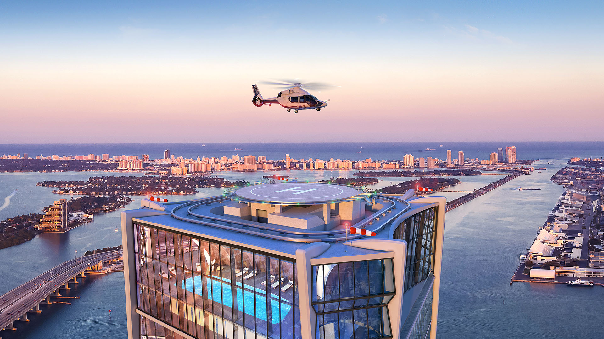 Rooftop helipad and pool at One Thousand Museum in Downtown Miami with a helicopter above the waterfront at sunset, serving luxury and ultra luxury condos.
