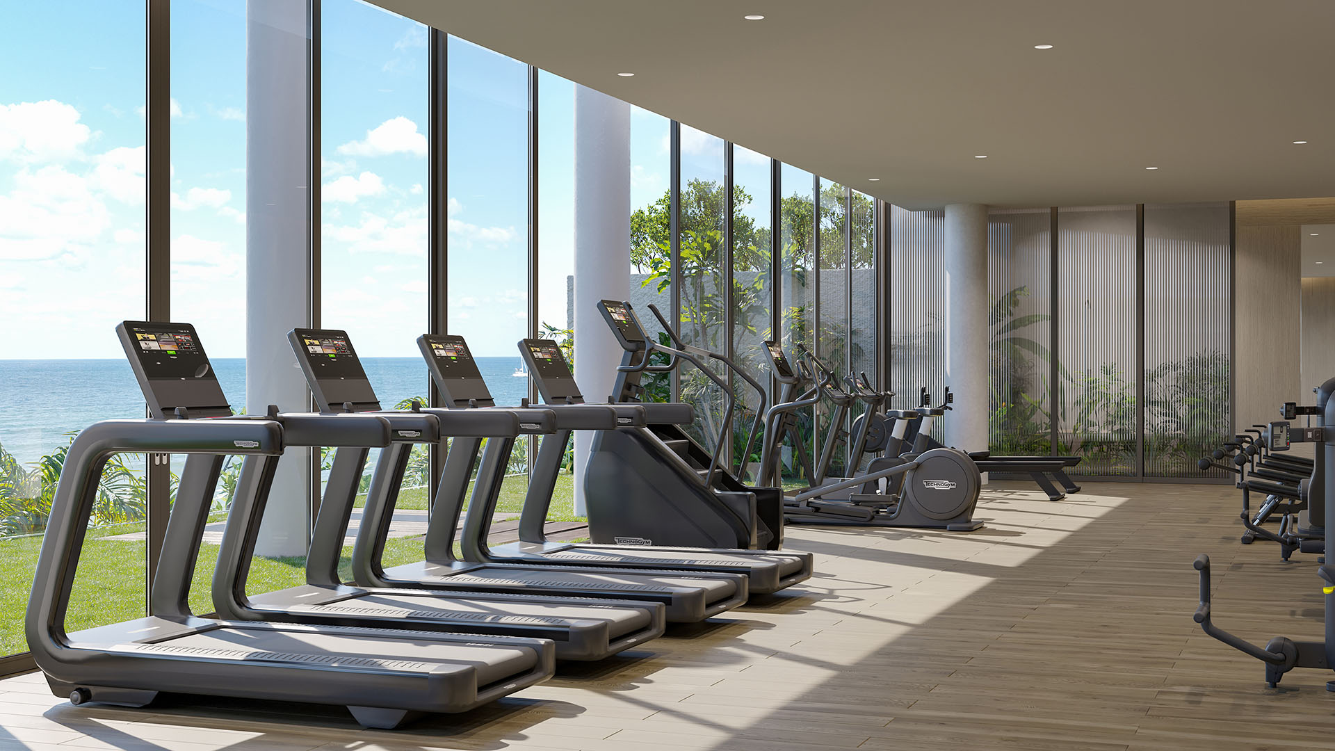 Oceanfront fitness center at Rosewood Residences Hillsboro Beach, Florida with treadmills and cardio equipment by floor-to-ceiling windows overlooking the Atlantic, luxury and ultra luxury preconstruction condos.