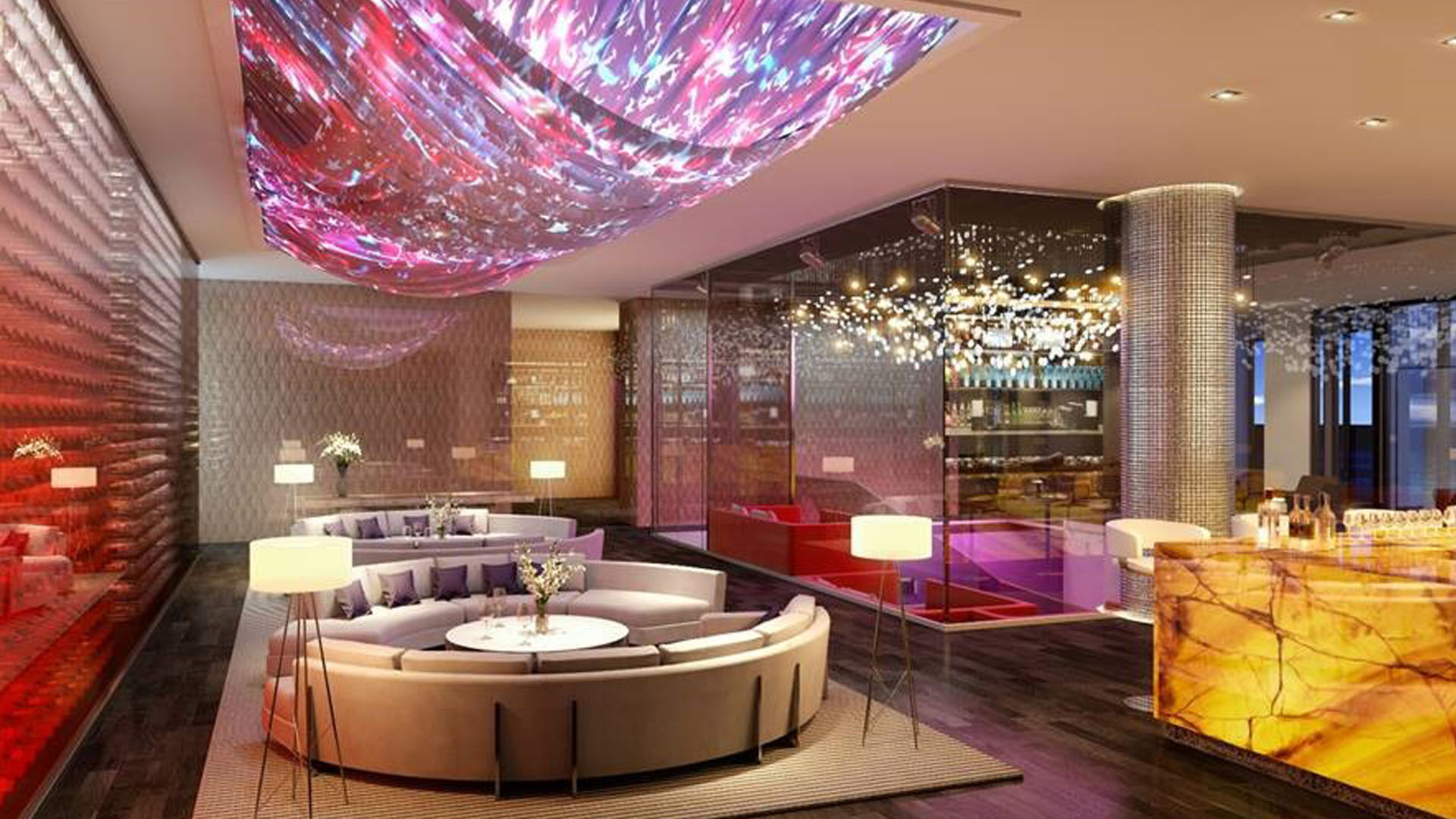 Lobby lounge with a dramatic ceiling installation, round seating, and warm lighting at The Estates at Acqualina, Sunny Isles Beach, a community of luxury and ultra luxury condos.