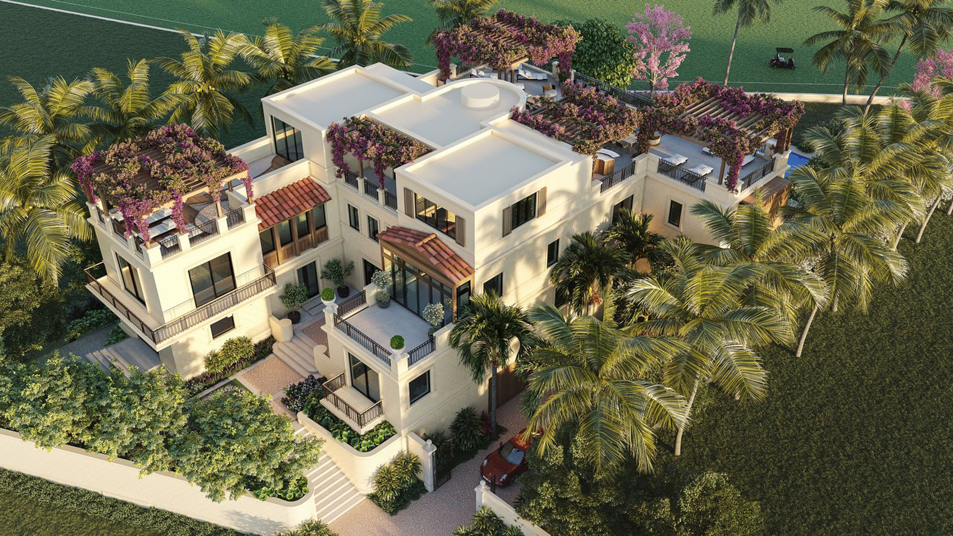 Aerial front entrance at The Links Estates, Fisher Island, Miami Beach, Florida, featuring gated driveway, rooftop garden terraces, palms, and bougainvillea pergolas - luxury and ultra luxury preconstruction condos and villa residences.