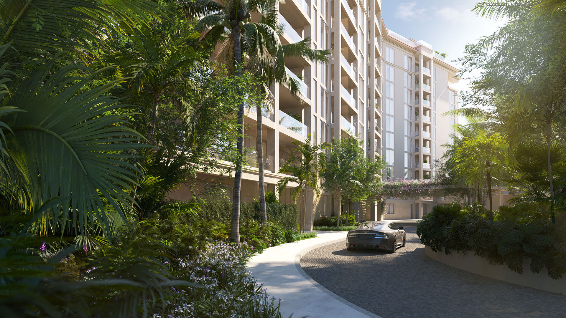 Tropical landscaped driveway approach to The Residences at Six Fisher Island on Fisher Island, Miami Beach, Florida, with palm-lined entry and modern facade, promoting luxury and ultra luxury preconstruction condos.