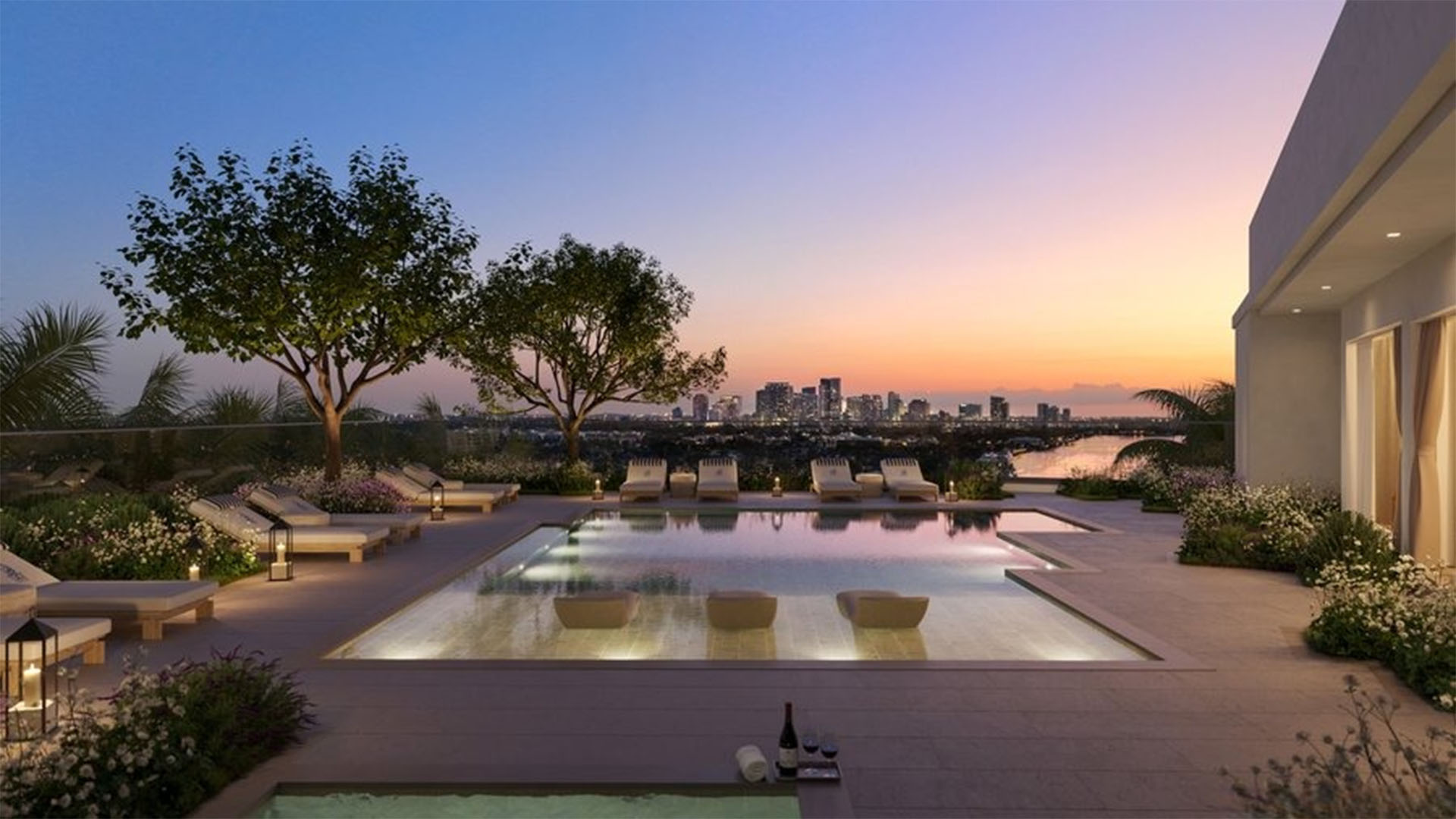 Rooftop pool terrace at The Ritz-Carlton Residences, Fort Lauderdale, showing amenities for luxury and ultra luxury condos, including a sunset lounge deck, in-water seating, and landscaped skyline views.