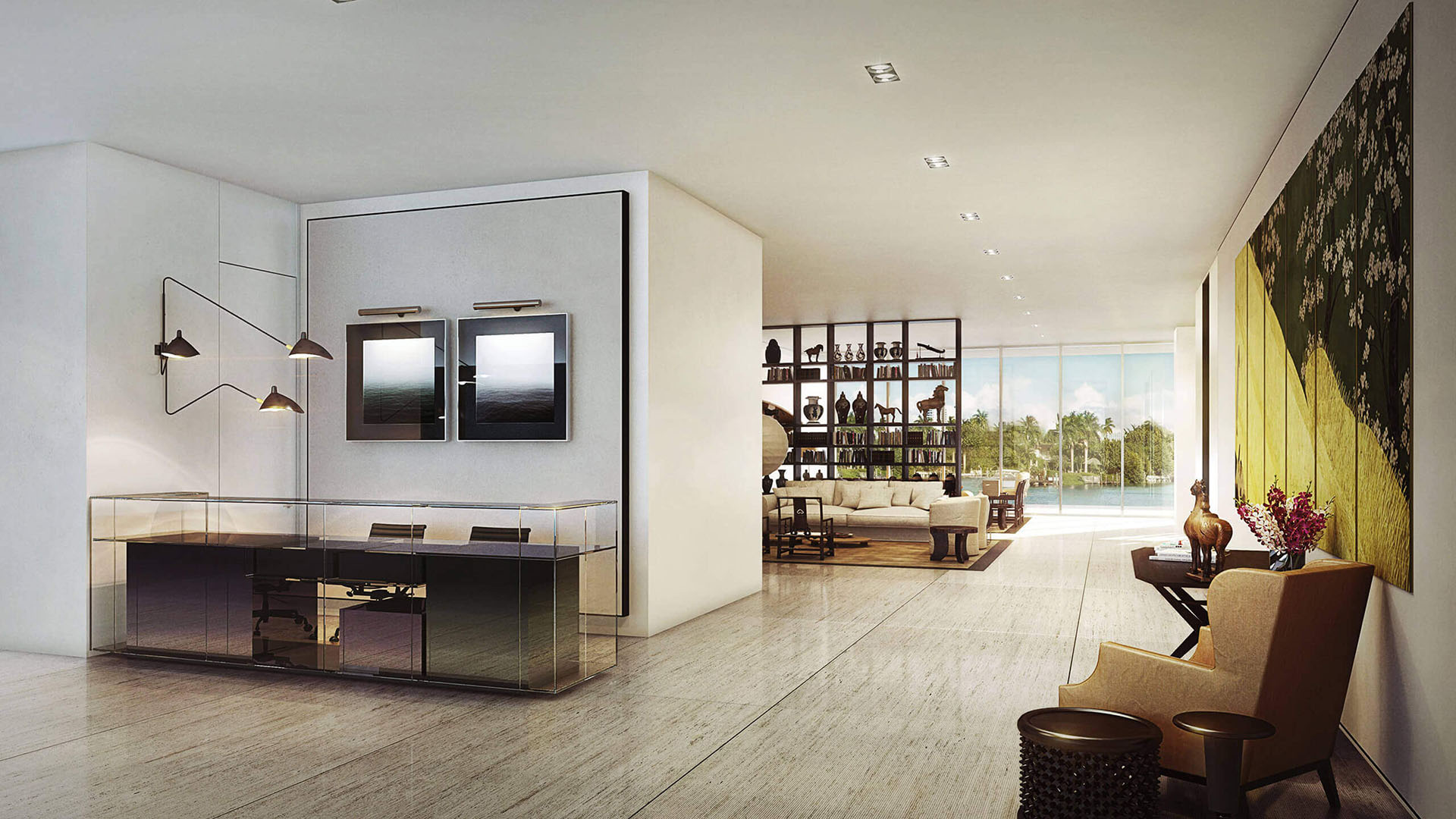 Modern entry foyer with a glass console desk, framed artwork and an open view to the waterfront living area at The Ritz-Carlton Residences Miami Beach in Miami Beach, inside the luxury and ultra luxury condos.
