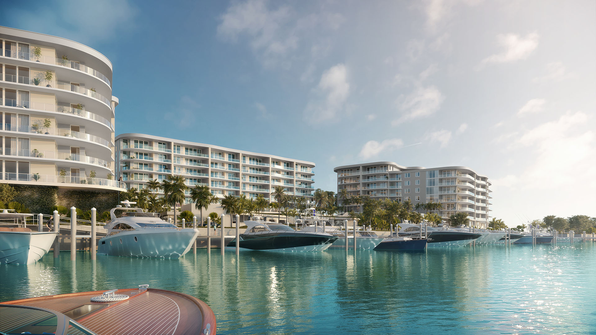 Daytime marina scene with private yacht slips and waterfront towers at The Ritz-Carlton Residences Palm Beach Gardens, Palm Beach Gardens, Florida, highlighting luxury and ultra luxury preconstruction condos on the Intracoastal Waterway.
