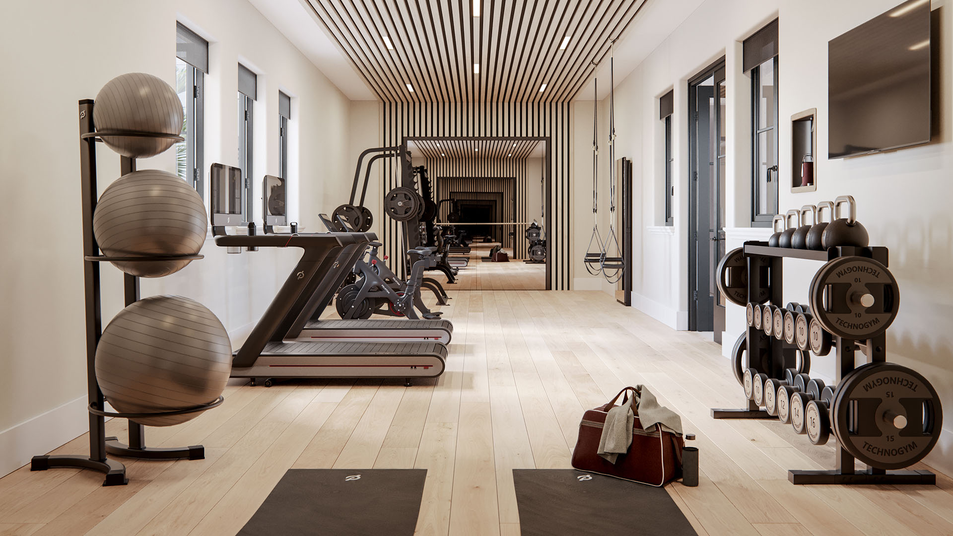 The Village at Coral Gables fitness center in Coral Gables, Miami with treadmills, bikes, free weights, mirrors and slat ceiling; luxury and ultra luxury preconstruction condos wellness amenity.