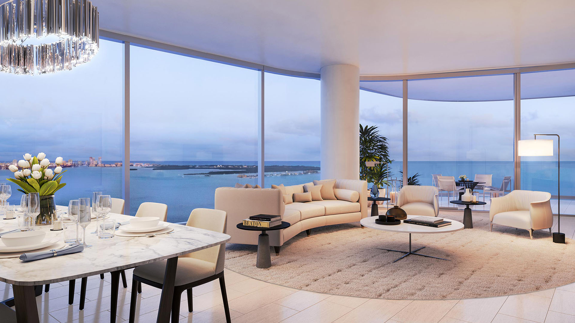 Una Residences Brickell, Miami luxury living room and dining area with floor-to-ceiling curved glass and Biscayne Bay views, inside ultra luxury preconstruction condos with designer furnishings and open-plan layout.